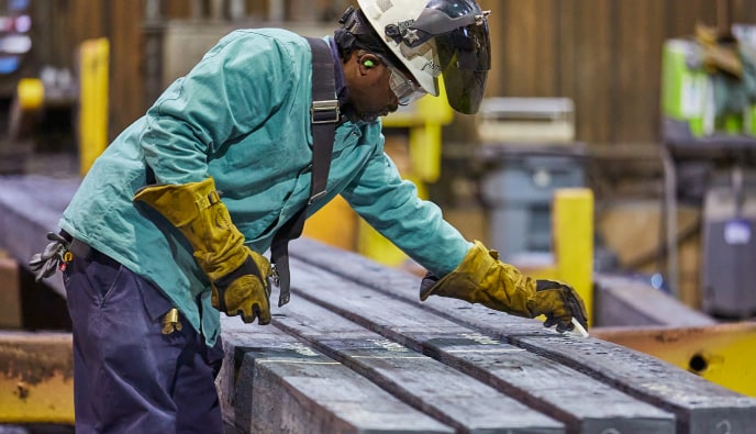 Worker marking steel
